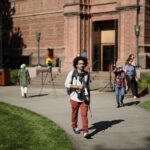 intern walking with camera