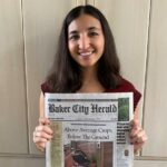 Joanna Mann holding newspaper